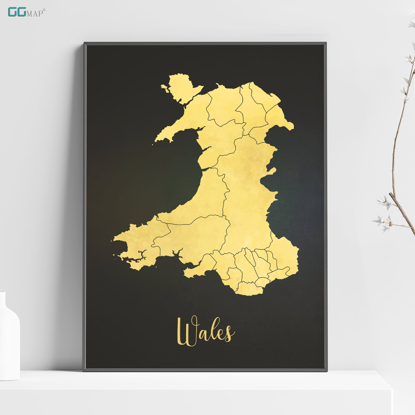 a black and yellow map of wales on a shelf