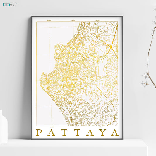 a map of pattaya in gold on a white shelf