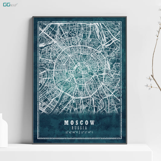 a poster of moscow on a shelf next to a vase